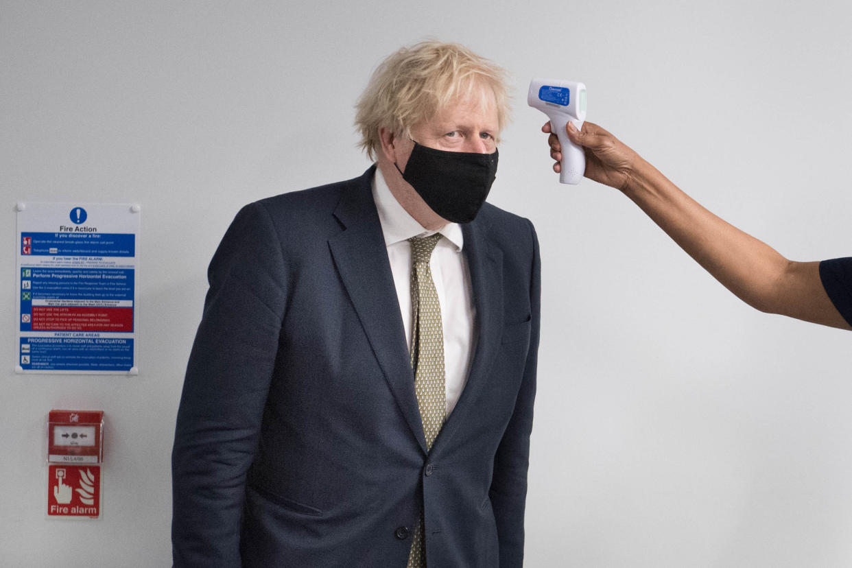 Prime Minister Boris Johnson has his temperature taken during a visit to view the vaccination programme at Chase Farm Hospital in north London, part of the Royal Free London NHS Foundation Trust. The NHS is ramping up its vaccination programme with 530,000 doses of the newly approved Oxford/AstraZeneca Covid-19 vaccine jab available for rollout across the UK.