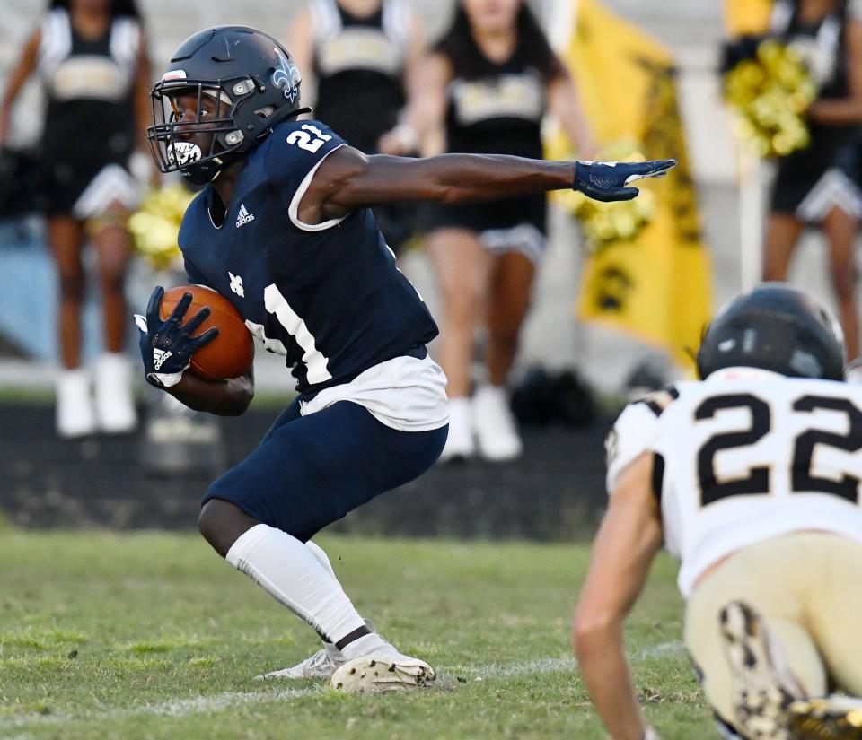 Sandalwood running back Jordan Bean (21) looks for running room during a 2021 game. The Saints face First Coast in Friday's first spring football game in Jacksonville.