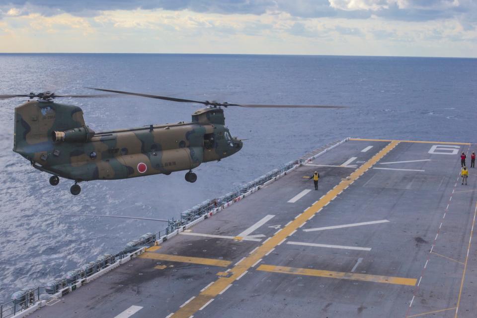 A Japanese CH-47 helicopter lands on the top of a US Navy amphibious assault ship in the Philippine Sea