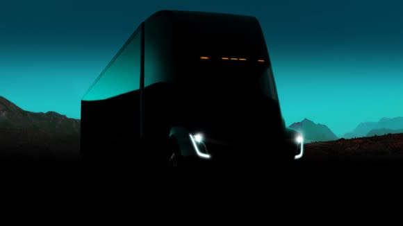 A silhouette of the Tesla Semi at dusk