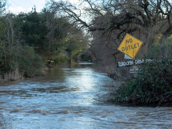 A flooded side street in Schellville, California, USA, on 14 February 2019 after strong weather hit the west coast of California. (EPA/Peter DaSilva)