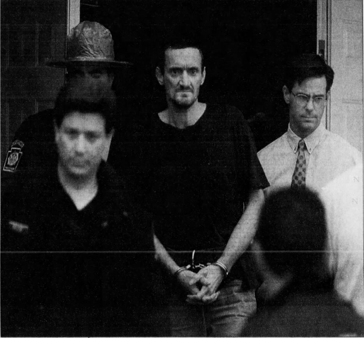 Norman Johnston being taken from a Pennsylvania State Police barracks in Avondale after his Aug. 20, 1999, capture.