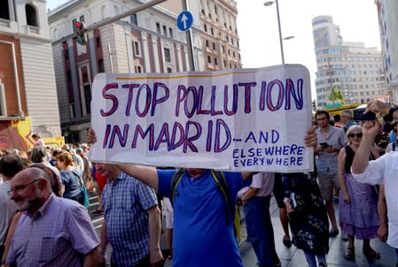 Demonstrators take part in a protest against Madrid's new conservative People's Party (PP) municipal government plans to suspend some anti-car emissions policies in Madrid's city center