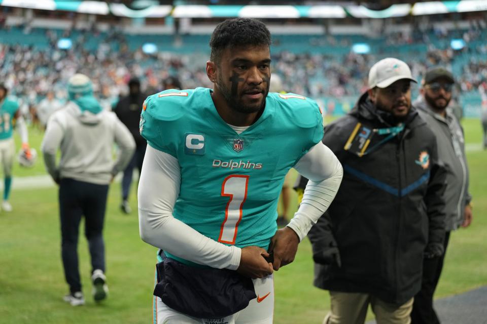 Tua Tagovailoa walks off the field following the Miami Dolphins' loss to the Green Bay Packers on Dec. 25, 2022.