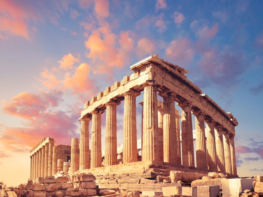 Parthenon temple on a sunset with pink and purple clouds. Acropolis in Athens, Greece - Image