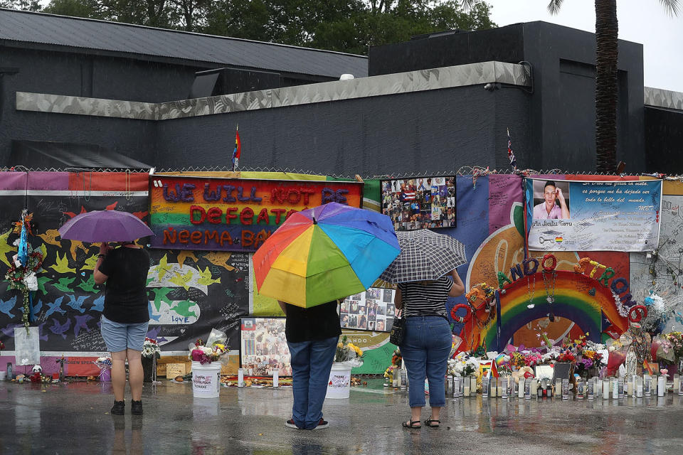 <p>People visit the memorial to the victims of the mass shooting setup around the Pulse gay nightclub one day before the one year anniversary of the shooting on June 11, 2017 in Orlando, Florida. (Joe Raedle/Getty Images) </p>