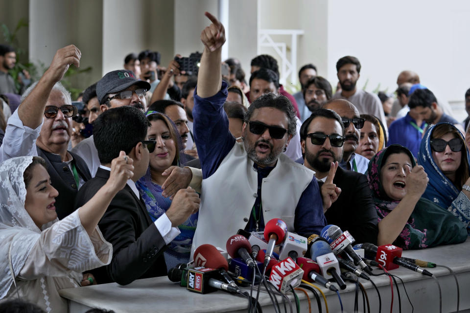 Supporters of imprisoned former Prime Minister Imran Khan's party Tehreek-e-Insaf, react after a Supreme Court decision in a case of reserved seats for women and minorities in the parliament, in Islamabad, Pakistan, Friday, July 12, 2024. Pakistan's top court on Friday ruled that the party of imprisoned former Prime Minister Khan is eligible for seats reserved in the parliament, a major blow to the country's weak coalition government. (AP Photo/Anjum Naveed)