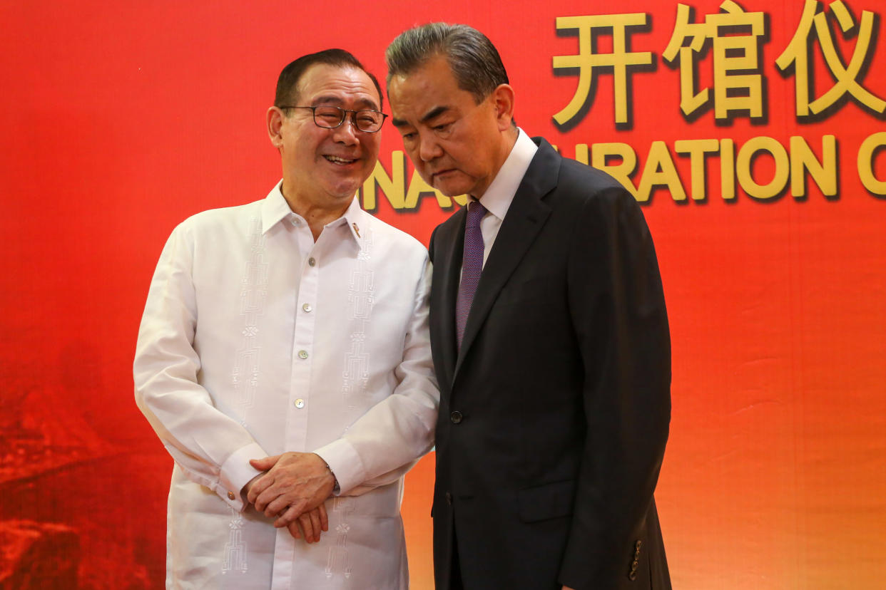 FILE PHOTO: Philippines' Secretary of Foreign Affairs Teodoro Locsin Jr. (L) talks to Chinese Foreign Minister Wang Yi during the inauguration of the Consulate General of China in Davao, in the southern island of Mindanao on October 28, 2018. (Photo: MANMAN DEJETO/AFP via Getty Images)