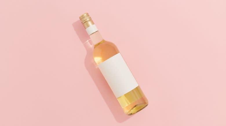 white wine on pink background