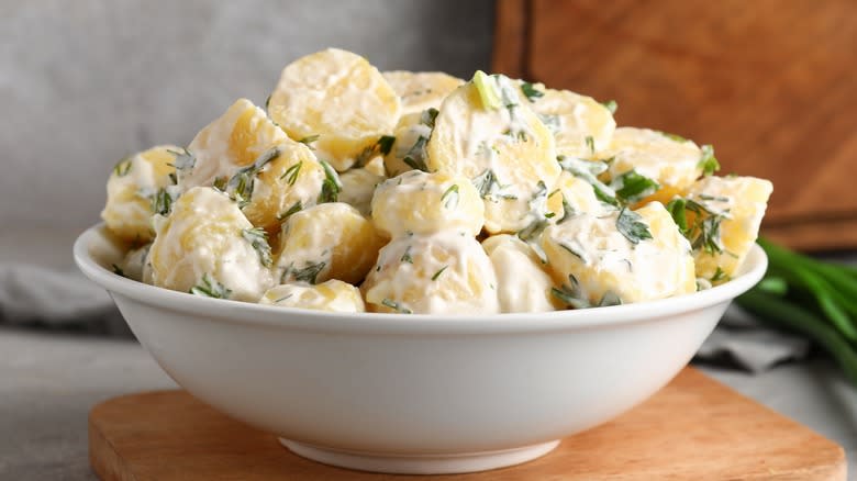 Bowl of creamy potato salad with herbs