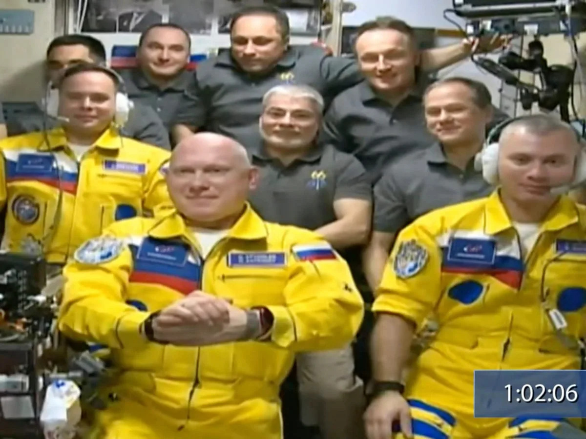 Russian cosmonauts boarded the International Space Station wearing yellow and bl..