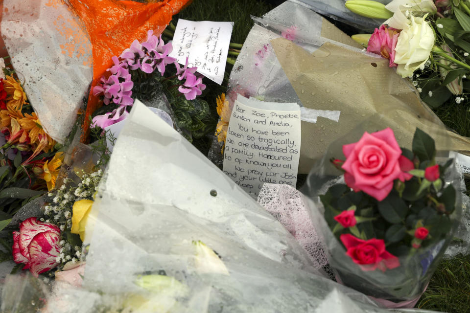 Floral tributes laid in front of a cross erected outside Chinnor Community Church in Chinnor, Oxfordshire, in memory of Zoe Powell, 29, and her three children - Phoebe, eight, Simeon, six, and Amelia, four - who were killed in a car accident on the A40 near Oxford on Monday night.