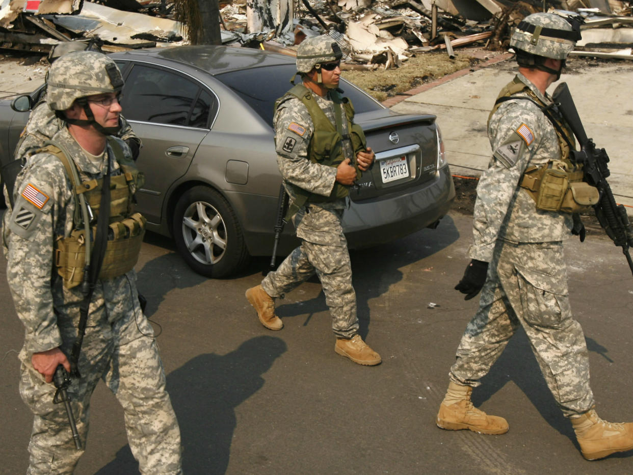 Members of the California National Guard patrol the Rancho Bernardo neighbourhood of San Diego amid a wildfire fight: REUTERS/John Gress