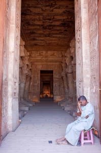 Frowning man outside and Egyptian temple