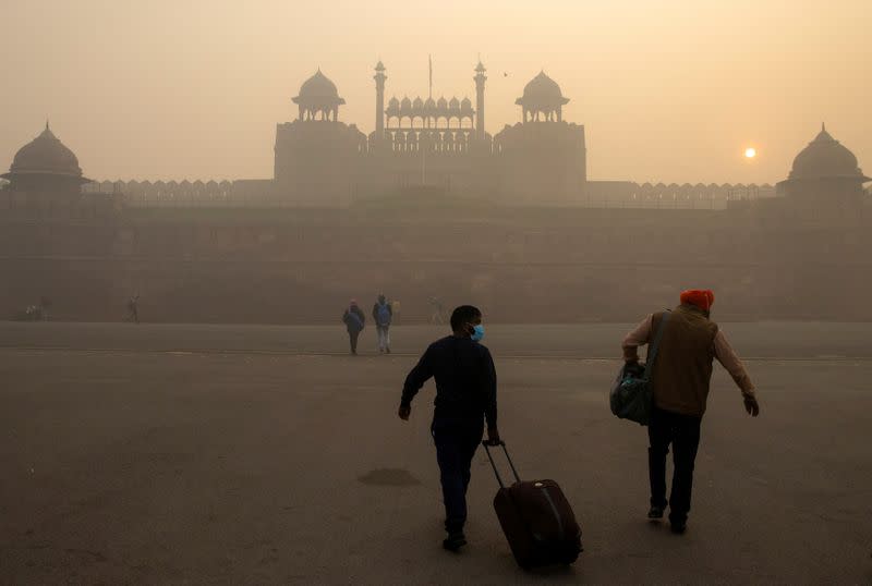 FILE PHOTO: People arrive to visit the Red Fort on a smoggy morning in the old quarters of Delhi