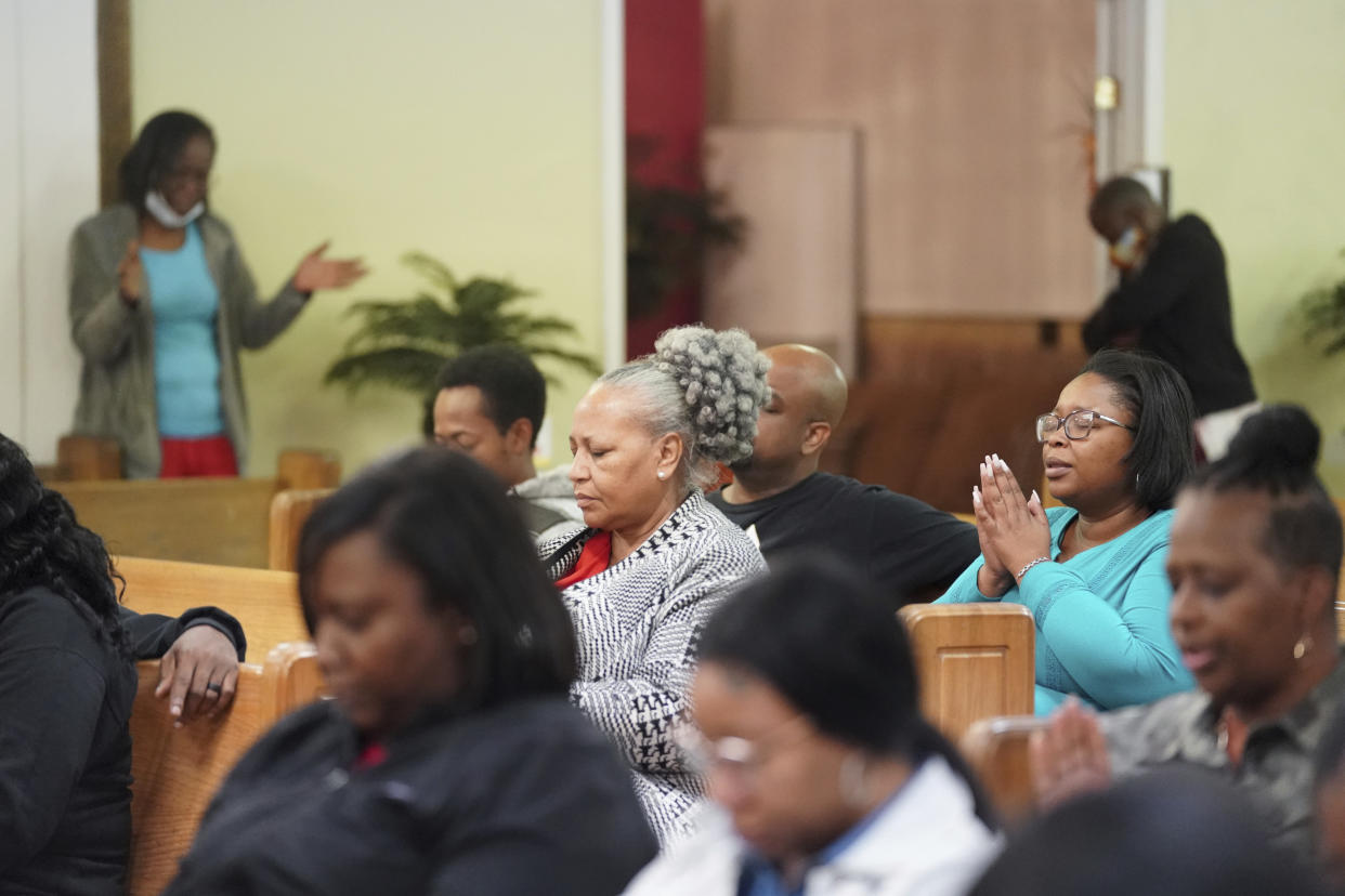 People pray during a vigil for a group of Americans recently kidnapped in Mexico at Word of God Ministries in Scranton, S.C., Wednesday, March 8, 2023. Two of the four Americans, all from South Carolina, were killed after being caught in a deadly shootout while traveling last week to Matamoros for one of them to get cosmetic surgery. (AP Photo/Sean Rayford)