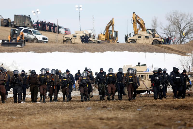 FILE PHOTO: Law enforcement officers advance into the main opposition camp against the Dakota Access oil pipeline near Cannon Ball