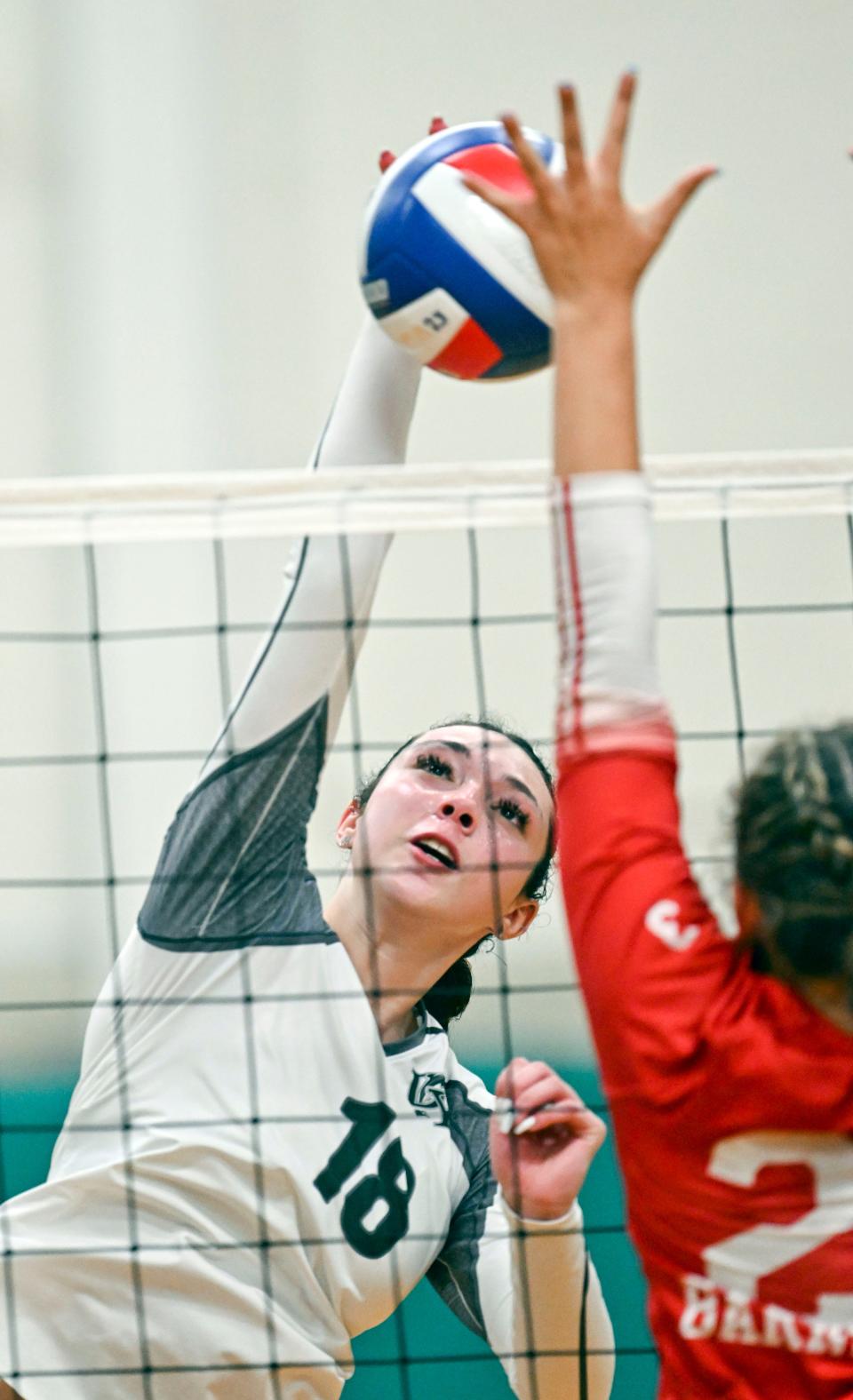 Mariah Eaton of D-Y spikes the ball at Charlotte Sullivan of Barnstable during a Sept. 18, 2023 match.