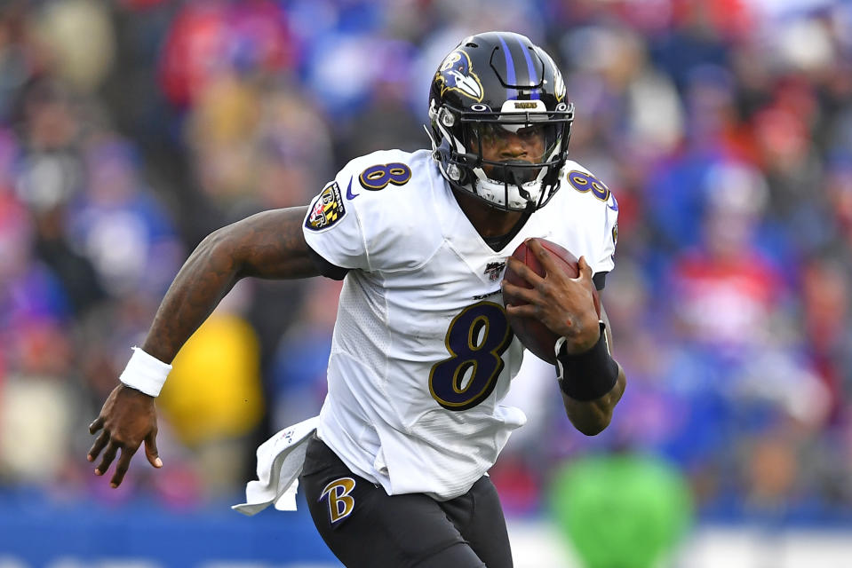 Baltimore Ravens quarterback Lamar Jackson (8) carries the ball during the second half of an NFL football game against the Buffalo Bills in Orchard Park, N.Y., Sunday, Dec. 8, 2019. (AP Photo/Adrian Kraus)