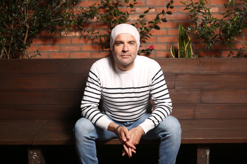 Francisco Zimone, owner of L'Antica Pizzeria da Michele, sits on a bench.