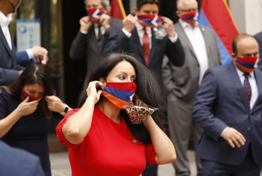 LOS ANGELES, CA - OCTOBER 05: LA City Council President Nury Martinez dons a face mask bearing the flag of the Republic Artsakh the tiny mountainous enclave recognized as part of Azerbaijan, but a population of ethnic Armenian, a number of elected officials posed for photos after they made statements at LA City Hall on the escalating conflict between Armenia and Azerbaijan. Their position is that the U.S. should call on Azerbaijan to cease fire and condemn its ally Turkey. For several weeks, Armenian-Americans across Los Angeles County have been staging demonstrations to bring awareness to the conflict pressing elected officials to speak. City Hall on Monday, Oct. 5, 2020 in Los Angeles, CA. (Al Seib / Los Angeles Times