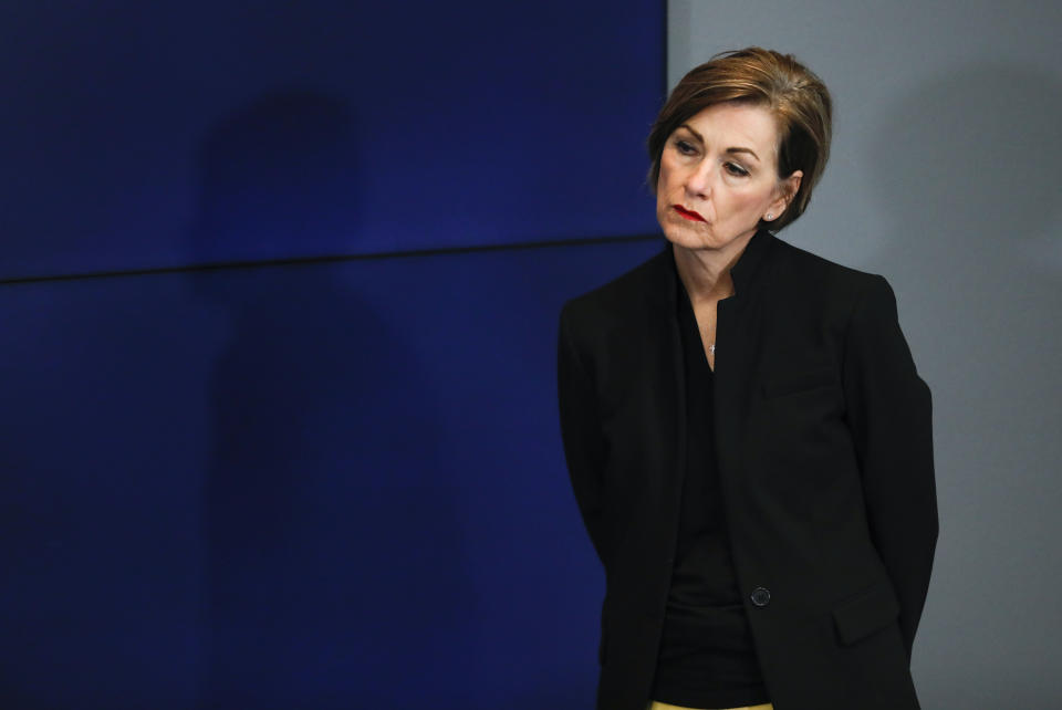 FILE - In this April 9, 2020, file photo Iowa Gov. Kim Reynolds listens to a question during an update to the state's response to the coronavirus outbreak during a news conference at the State Emergency Operations Center in Johnston, Iowa. Democratic State Auditor Rob Sand has questioned the data Reynolds is using to justify allowing more freedom of movement than in neighboring states. (AP Photo/Charlie Neibergall, Pool, File)