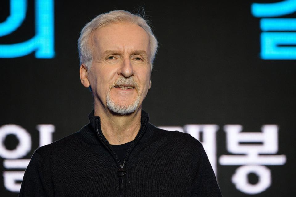 James Cameron wearing a black shirt and smiling