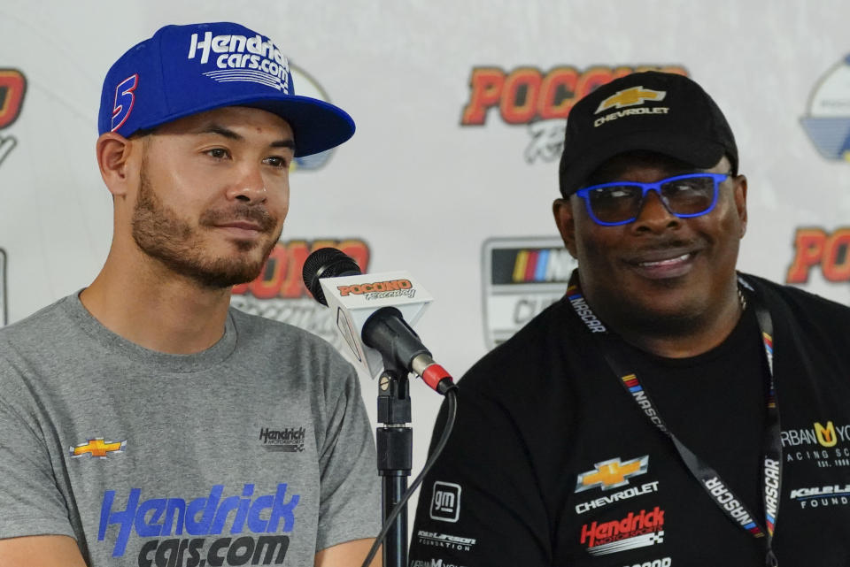 FILE - Anthony Martin, right, who established the Urban Youth Racing School, speaks at a news conference as he sits with Kyle Larson driver of car No. 5, in the NASCAR Cup Series before the scheduled races at Pocono Raceway, Sunday, June 27, 2021, in Long Pond, Pa. The Urban Youth Racing School, the Philly-based program that creates opportunities in racing for minorities, played a crucial role in Larson's personal comeback. Founders Anthony and Michelle Martin were at Phoenix Raceway when Larson won the champion and said it was proof this second chance was well deserved. (AP Photo/Matt Slocum, File)