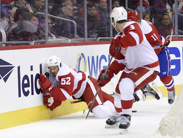 Detroit Red Wings defenseman Jonathan Ericsson (52), of Sweden, slams into the boards during the first period of an NHL hockey game against the Washington Capitals, Thursday, Feb. 9, 2017, in Washington. Washington Capitals center Nicklas Backstrom (19), of Sweden, was called for boarding on the play. (AP Photo/Nick Wass)