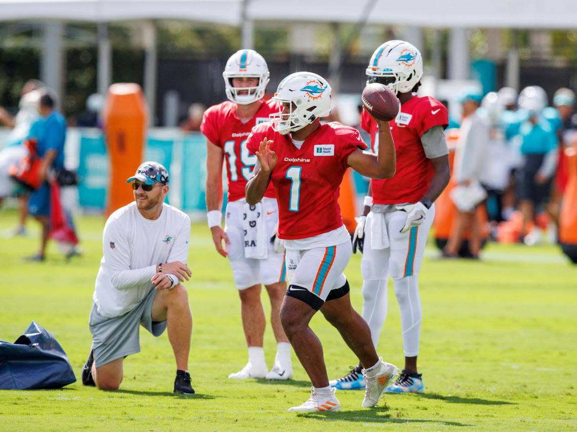 Miami Dolphins quarterbacks coach and passing game coordinator Darrell Bevell works with Dolphins quarterbacks Tua Tagovailoa (1) Teddy Bridgewater (5) and Skylar Thompson (19) during an NFL football training camp with the Philadelphia Eagles at Baptist Health Training Complex in Hard Rock Stadium on Wednesday, August 24, 2022 in Miami Gardens, Florida.