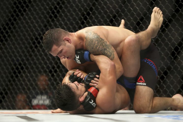 Chris Weidman (top) submitted Kelvin Gastelum in the third round on Saturday to win a three-fight losing streak. (The Associated Press)