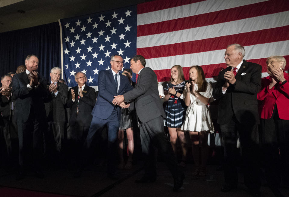 Georgia Republican Lt. Gov. Casey Cagle, left, and Secretary of State Brian Kemp shake hands during a unity rally, Thursday, July 26, 2018, in Peachtree Corners, Ga. The pair faced off against each other in a heated gubernatorial runoff race which Kemp won. (AP Photo/John Amis)