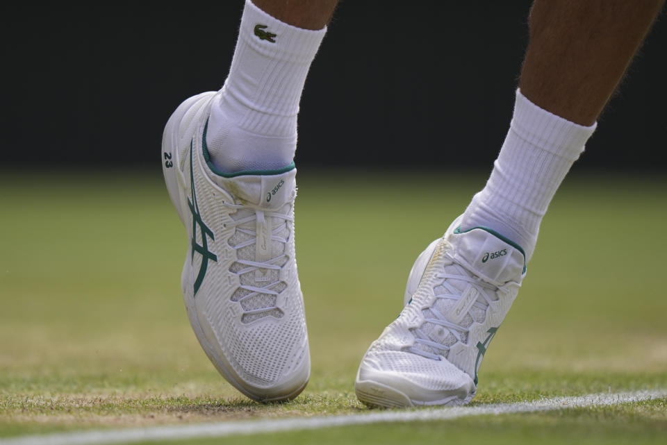 A detail on the shoes of Serbia's Novak Djokovic showing '23' in reference to the number of Grand Slam singles titles he has won, during his men's singles match against Poland's Hubert Hurkacz on day eight of the Wimbledon tennis championships in London, Monday, July 10, 2023. (AP Photo/Alberto Pezzali)