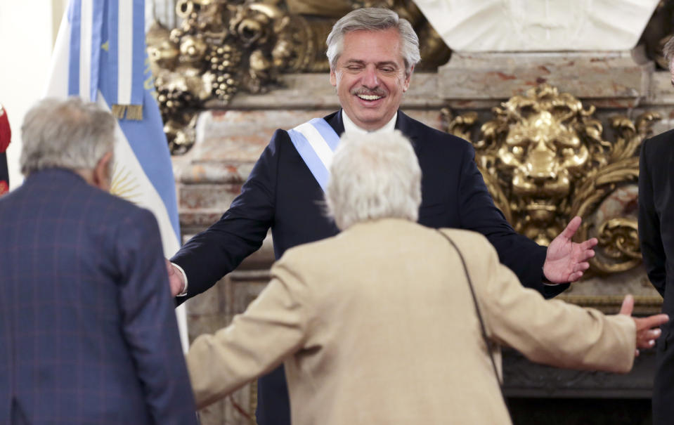 Argentina's President Alberto Fernandez, center, greets former Uruguayan President Jose Mujica, left, and his wife Lucía Topolansky, at the presidential palace in Buenos Aires, Argentina, Tuesday, Dec. 10, 2019. Fernandez became president of Argentina on Tuesday, returning the country's Peronist political movement to power amid an economic crisis and rising poverty. (AP Photo/Daniel Jayo)