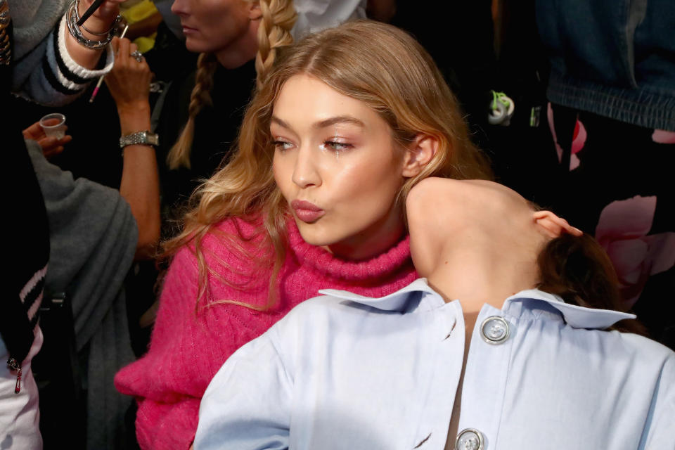 <p>Bella and Gigi share a loving sisterly moment backstage before the Anna Sui show. <em>[Photo: Getty]</em> </p>