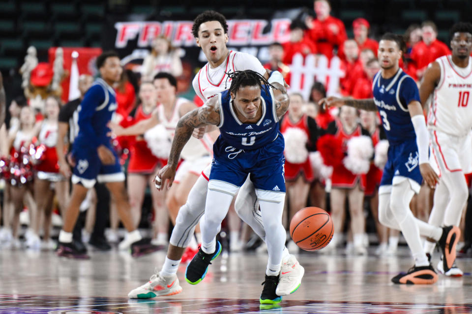 St. Peter's Peacocks guard Latrell Reid (0) tries to gain control of the ball while being defended by Fairfield Stags guard Brycen Goodine (2) during the first half at Jim Whelan Boardwalk Hall. Mandatory Credit: John Jones-USA TODAY Sports