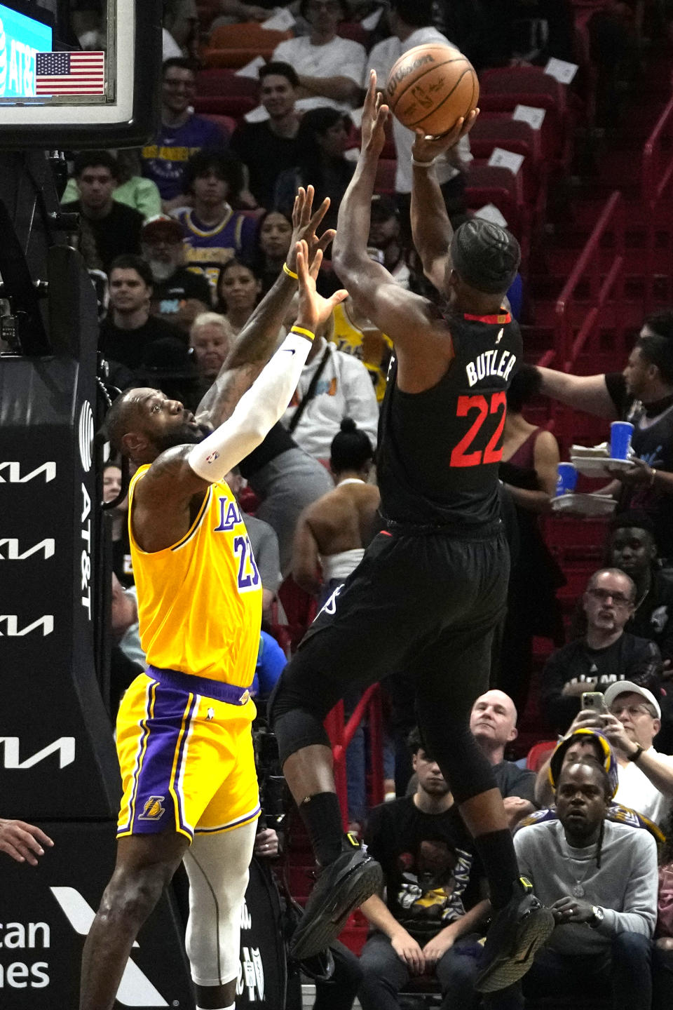 Miami Heat forward Jimmy Butler (22) goes to the basket as Los Angeles Lakers forward LeBron James, left, defends during the first half of an NBA basketball game, Monday, Nov. 6, 2023, in Miami. (AP Photo/Lynne Sladky)