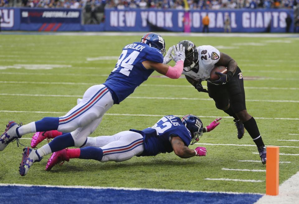 <p>New York Giants outside linebacker Mark Herzlich (94) and Jonathan Casillas (52) stop Baltimore Ravens’ Terrance West (28) on fourth down near the goal line during the second half of an NFL football game, Sunday, Oct. 16, 2016, in East Rutherford, N.J. (AP Photo/Seth Wenig) </p>