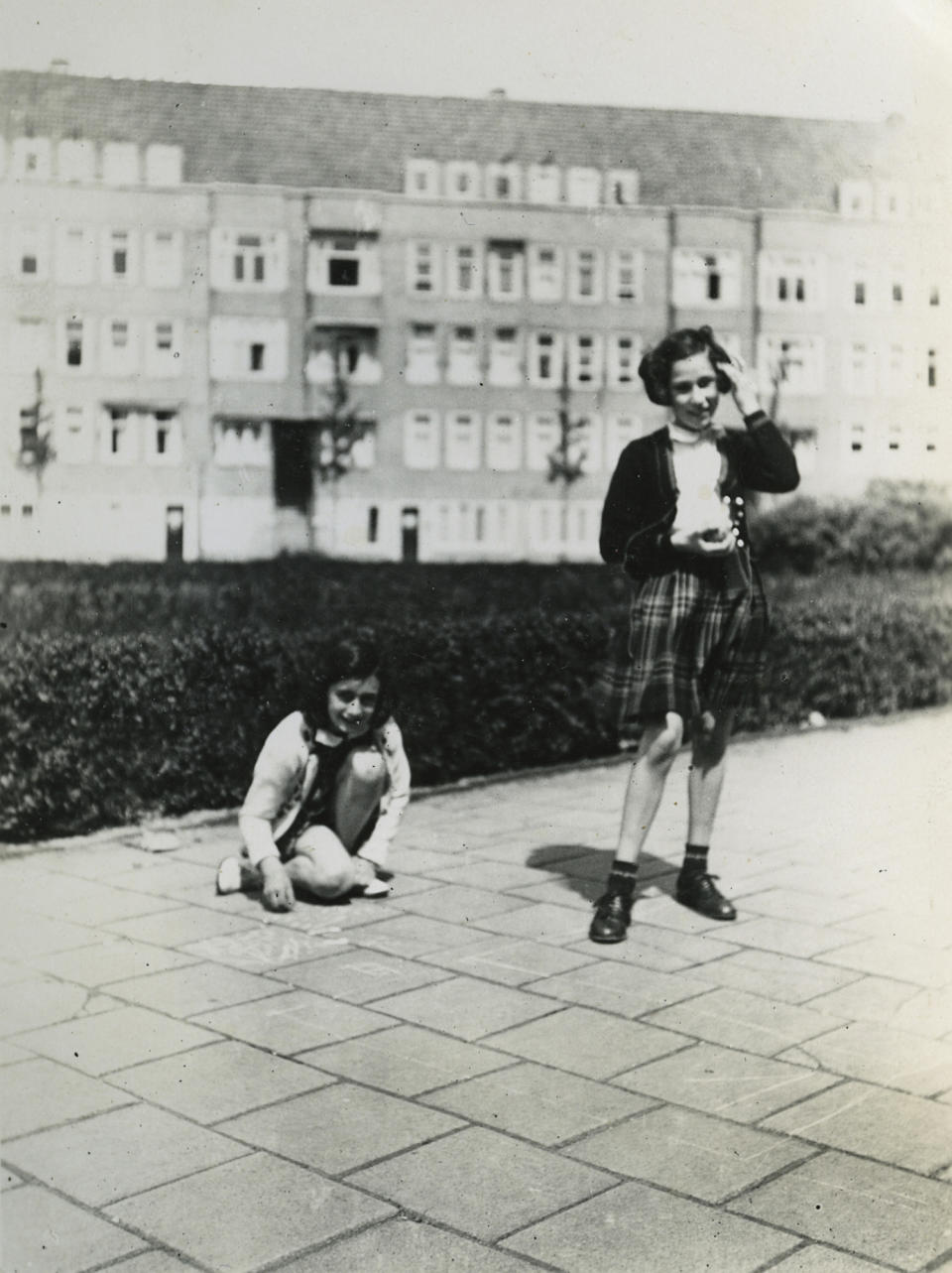 In this May 1941 photo provided by the Anne Frank House Amsterdam on Tuesday, Feb. 4, 2014, Anne Frank, left, plays with her friend Hanneli Goslar, right, on the Merwedeplein square in Amsterdam. Shortly before Anne Frank and her family went into hiding from the Nazis, she gave away some of her toys to non-Jewish neighborhood girlfriend Toosje Kupers for safekeeping. The toys have now been recovered and Anne's tin of marbles will go on display for the first time this week at an art gallery in Rotterdam, the Anne Frank House Museum says. (AP Photo/Anne Frank House Amsterdam/Anne Frank Fonds Basel photo collections)