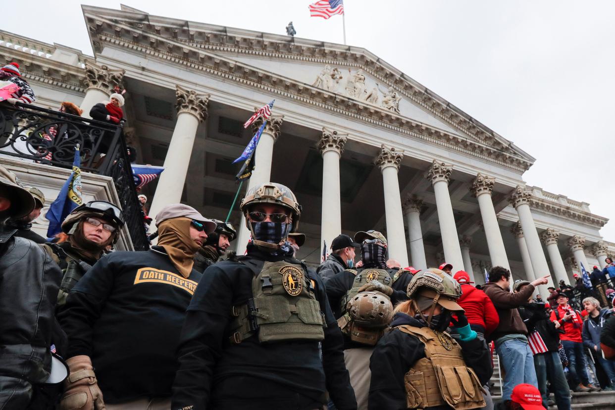 Members of the Oath Keepers militia group occupying the east front steps of the US Capitol in Washington on 6 January 2021 (Jim Bourg/Reuters)