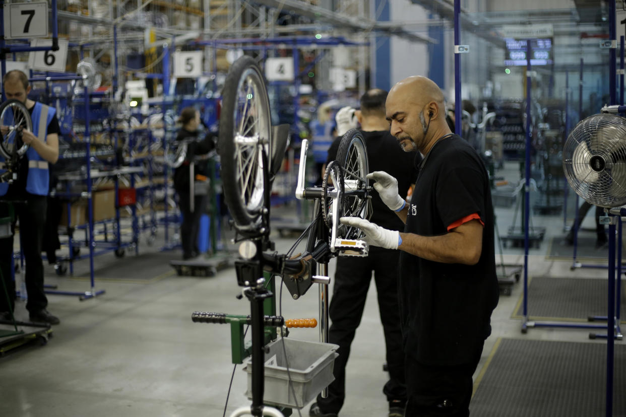 Brompton folding bicycles are assembled by hand at the Brompton factory in west London, Tuesday, Nov. 24, 2020.  The team at Brompton Bicycles company thought they were prepared for Britain's Brexit split with Europe, but they face uncertainty about supplies and unexpected new competition from China, all amid a global COVID pandemic.(AP Photo/Matt Dunham)