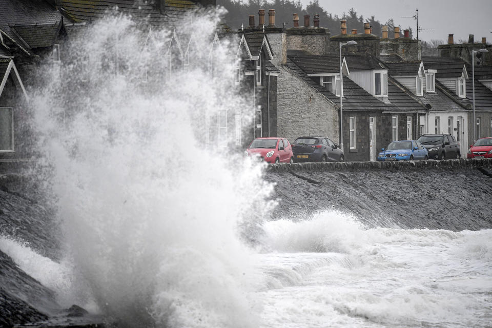 Waves crash against the harbour wall in the Scottish town of Port William. (Getty)