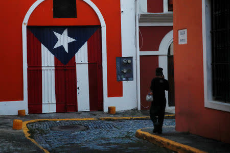 A man walks down a street in the Hurricane Maria affected area of Old San Juan, Puerto Rico, October 12, 2017. REUTERS/Shannon Stapleton