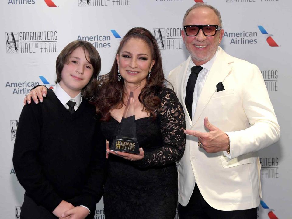 <p>L. Busacca/Getty</p> Gloria Estefan with her husband Emilio Estefan and their grandson Sasha Estefan-Coppola backstage at the 2023 Songwriters Hall of Fame Induction and Awards Gala on June 15, 2023 in New York City. 