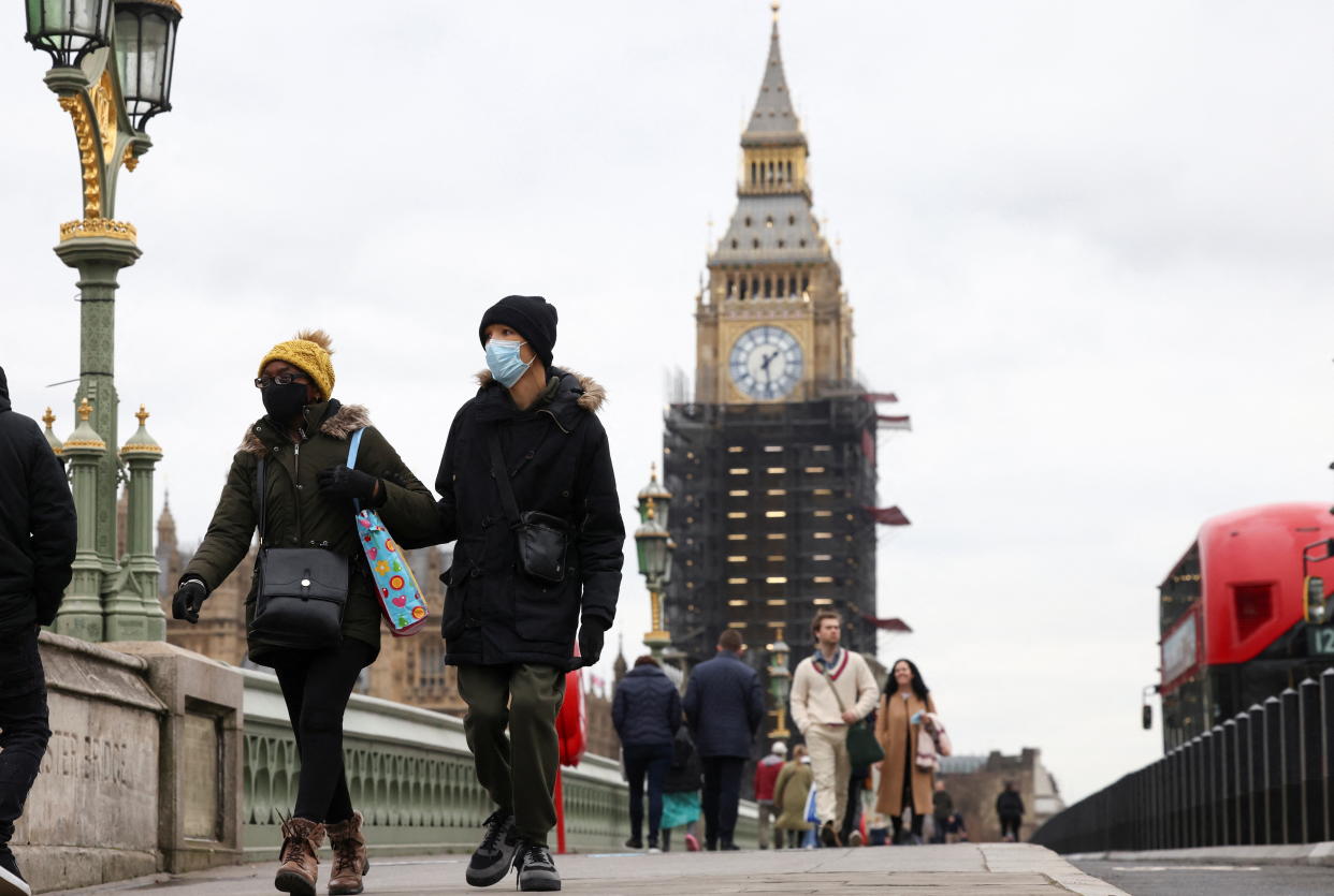 People wearing protective face masks walk over Westminster Bridge in front of the Big Ben, in London. The pandemic has affected different parts of the economy in 'very different' ways, research found. 