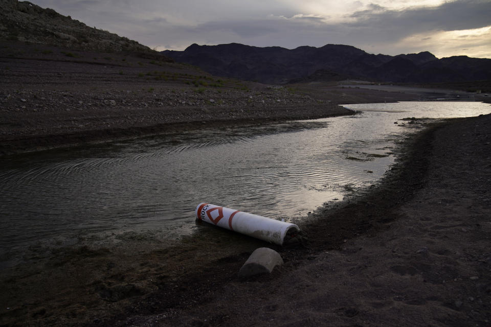 FILE - A buoy once used to warn of a submerged rock rests on the ground along the waterline near a closed boat ramp on Lake Mead at the Lake Mead National Recreation Area, Friday, Aug. 13, 2021, near Boulder City, Nev. The American West's megadrought deepened so much last year that it is now the driest it has been in at least 1200 years and a worst-case scenario playing out live, a new study finds.(AP Photo/John Locher, File)
