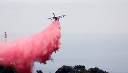 An air tanker drops fire retardant while battling the Wilson Fire near Mount Wilson in the Angeles National Forest in Los Angeles, California, U.S. October 17, 2017. REUTERS/Mario Anzuoni