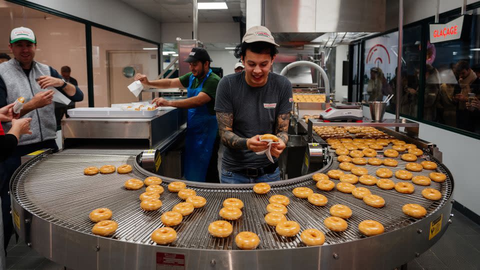 Krispy Kreme workers prepare donuts in the firm's first store in France on December 4. - Dimitar Dilkoff/AFP/Getty Images