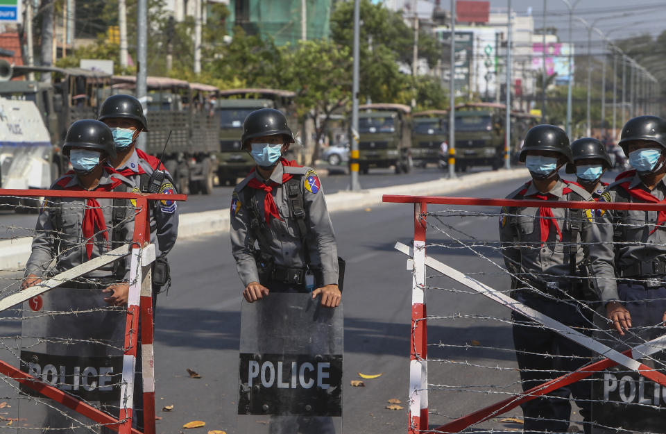 Police barricade a road to prevent anti-coup protesters from marching in Mandalay, Myanmar, Wednesday, Feb. 24, 2021. Protesters against the military's seizure of power in Myanmar were back on the streets of cities and towns on Wednesday, days after a general strike shuttered shops and brought huge numbers out to demonstrate. (AP Photo)