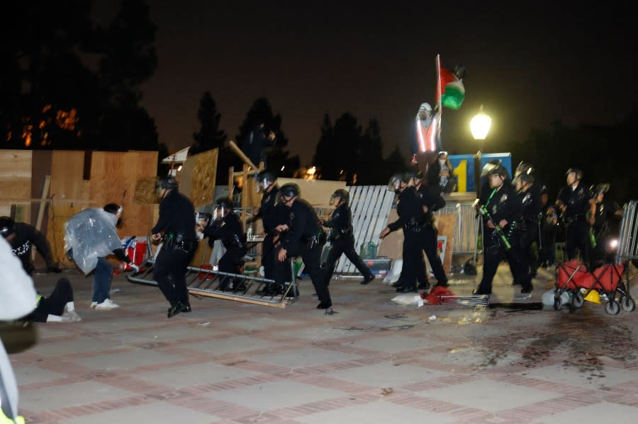 Police breach the encampment of Pro-Palestinian students demonstrating on the campus of the University of California, Los Angeles (UCLA) in Los Angeles, California, early on May 2, 2024. (Photo by ETIENNE LAURENT/AFP via Getty Images)